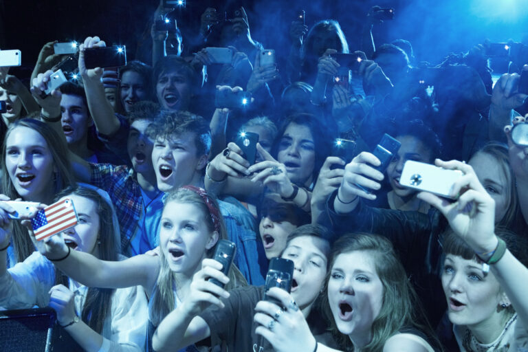 fans at a concert screaming enthusiastic phones