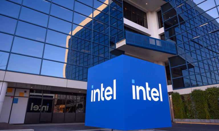 intel cube statue with intel logo with large building in background intel