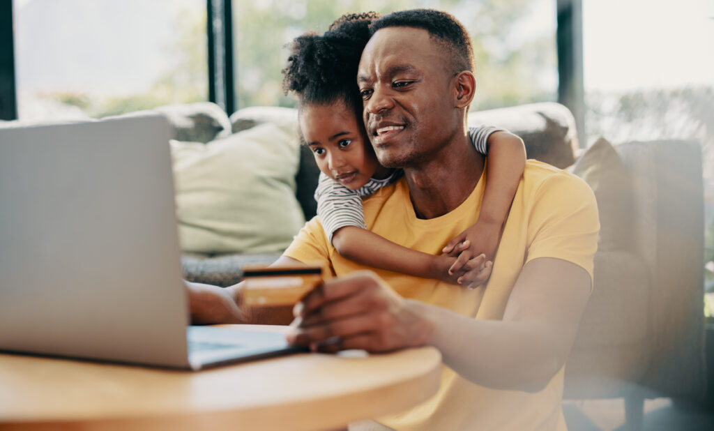 a person using a credit card with a child