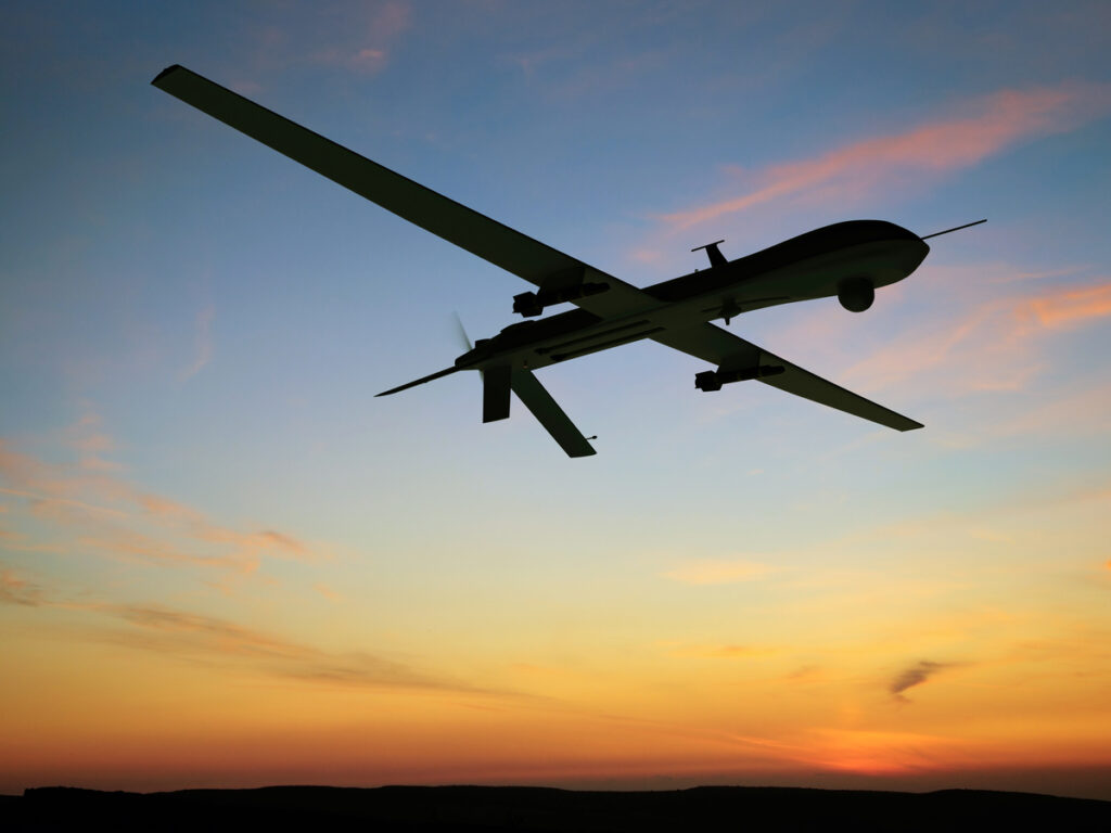 predator drone flying at dawn